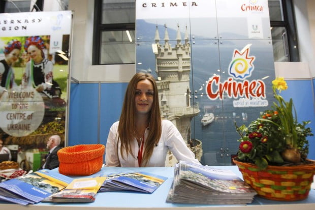 Volunteer-waits-for-visitors-at-booth-representing-Ukraine-during-opening-da-2-